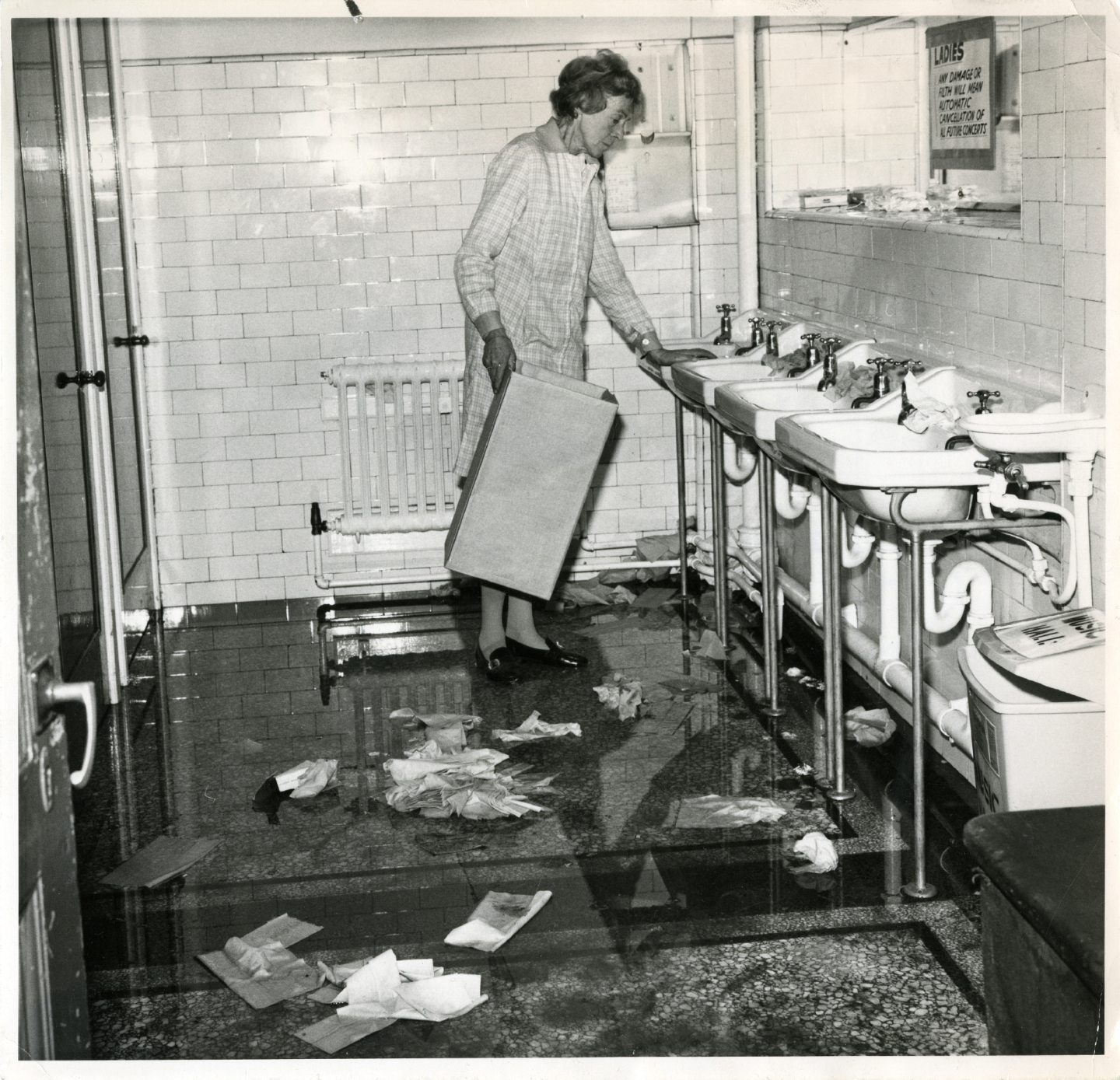 Marjory Christie, femme de ménage au Music Hall d'Aberdeen, examine les dégâts dans les toilettes des femmes, le 24/09/1973